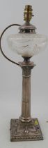 A silver oil lamp, with cut glass reserve on a Corinthian column, the square base decorated with