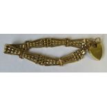 A 15ct yellow gold gate bracelet, with 18ct padlock clasp, weight 21.9g