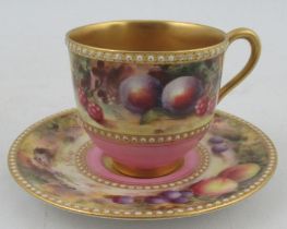 A Royal Worcester miniature coffee cup and saucer, decorated with a band of fruit to a mossy