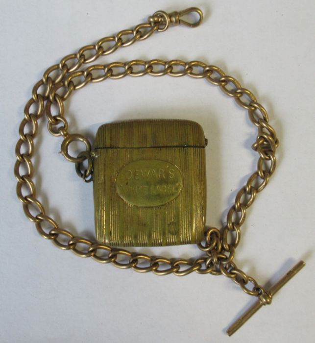 A 9ct yellow gold oval link watch chain, suspending a gilt metal vesta, case stamped 'Dewar's