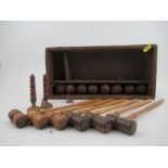 A late Victorian/Edwardian table top miniature croquet set, comprising six mallets, mallet length