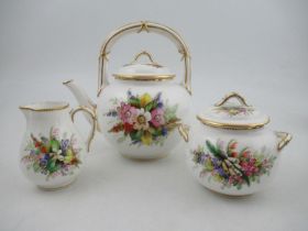 A Royal Worcester tea pot, decorated with hand painted flowers to a white ground, together with a