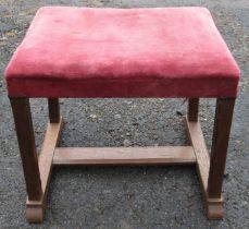 An Arts and Crafts oak stool, with out swept square stop chamfered legs on sledge feet, united by