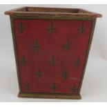 A wooden waste paper bin, decorated with fleur de Lys to a red ground, 12.5ins x 12.5ins, height