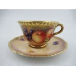 A Royal Worcester cabinet cup and saucer, decorated with hand painted fruit, signed N.Creed