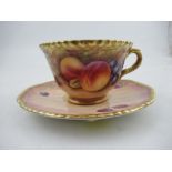 A Royal Worcester cabinet cup and saucer, decorated with hand painted fruit, the cup, signed N.