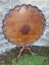 A Georgian design mahogany supper table, with floral carved top and leaves to a cabriole base, 34.