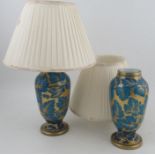 A pair of blue glass lamp bases, with gilt leaf decoration, one drilled, height of vases 10ins