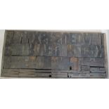 A wooden tray, containing vintage wooden printing poster type , mostly uppercase