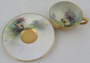 A Royal Worcester miniature tea cup and saucer, the saucer and the interior of the cup decorated