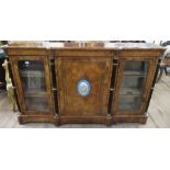 A Victorian walnut credenza, the central door inset with a Sevre style porcelain plaque with a
