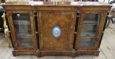 A Victorian walnut credenza, the central door inset with a Sevre style porcelain plaque with a