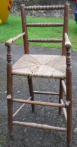 A child's high chair or correction chair, with bobbin turning and wicker seat