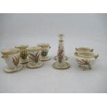Four Royal Worcester vases, decorated with hand painted flowers and having jewelled decoration,