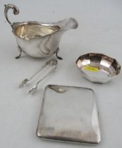 A silver sauce boat, together with a silver cigarette case, a pair of silver sugar tongs and a