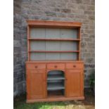 A pine dresser, with boarded plate rack over base width 59ins, height 81ins, depth 17ins