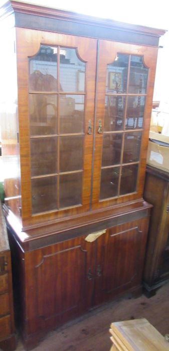 A mahogany cabinet, with glazed upper section and cupboard to the base