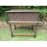 An antique oak Bible Box with carved decoration raised on a stand width 226ins total height 27ins,