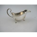 A silver sauce boat, with bead edge, raised on shell feet, Birmingham 1938, weight 8oz