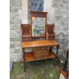 An Edwardian mahogany dressing table, the swing mirror flanked by two banks of jewellery drawers,