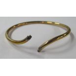 A 9ct yellow gold bangle, set diamond to each terminal, weight approx. 20g