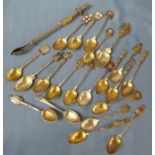 A collection of silver and white metal commemorative spoons, together with a pickle spoon