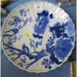 An Oriental blue and white wall plate, with scalloped edge, diameter 12ins