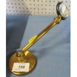 A magnifying glass, on brass support