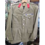 A military Army issue jacket, with badge ribbons and stitched badges to the lapels