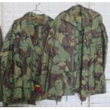 Two army issue camouflage jackets and trousers, one pair of trousers with belt