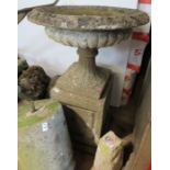 A garden urn, on rectangular base, diameter 23ins, height 36ins