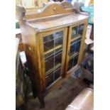 An oak glazed cabinet, together with similar bookcase, width 29ins, height 44ins