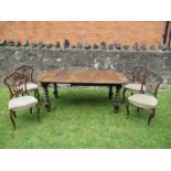 An oak extending dining table with one extra leaf raised on barley twist legs, fully extended length