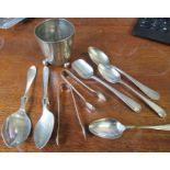 A collection of flatware, some being silver, together with a white metal beaker