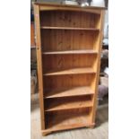 A modern pine bookcase, with adjustable shelves, height 70.5ins, width 33ins