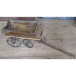 An Antique dog cart, with metal wheels