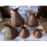 A set of five graduated copper jugs