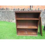 A bookcase, with carved decoration, width 40ins, depth 12ins, height 45ins