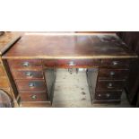 An Antique stained pine desk, fitted with nine drawers around the kneehole, 53ins x 28ins, height