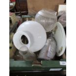 A box of assorted oil lamp parts including chimneys, shades etc