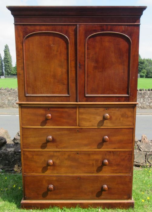 A Victorian mahogany linen press cupboard, the upper section fitted with slides, the base with