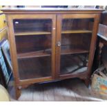 An oak wall cabinet, having a pair of glazed doors and adjustable shelves, width 42ins, depth 13.