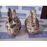 A pair of Oriental style models of rabbits, decorated in the Imari palette