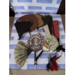 A collection of assorted fans, including oriental style examples, peacock etc