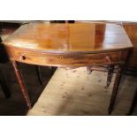 A mahogany bow front cross banded table, fitted with a frieze drawer, on ring turned legs, width