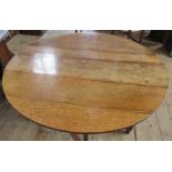 An Antique oak gateleg table, diameter 54.5ins, height 28ins