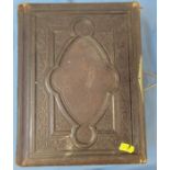 A Victorian photograph album, with embossed leather cover and flowers to some pages