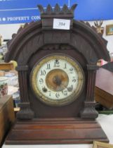 A 19th century mantle clock, with carved decoration, height 15ins