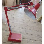 A red angle poise desk lamp