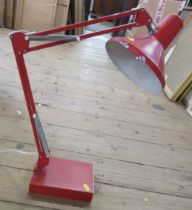 A red angle poise desk lamp